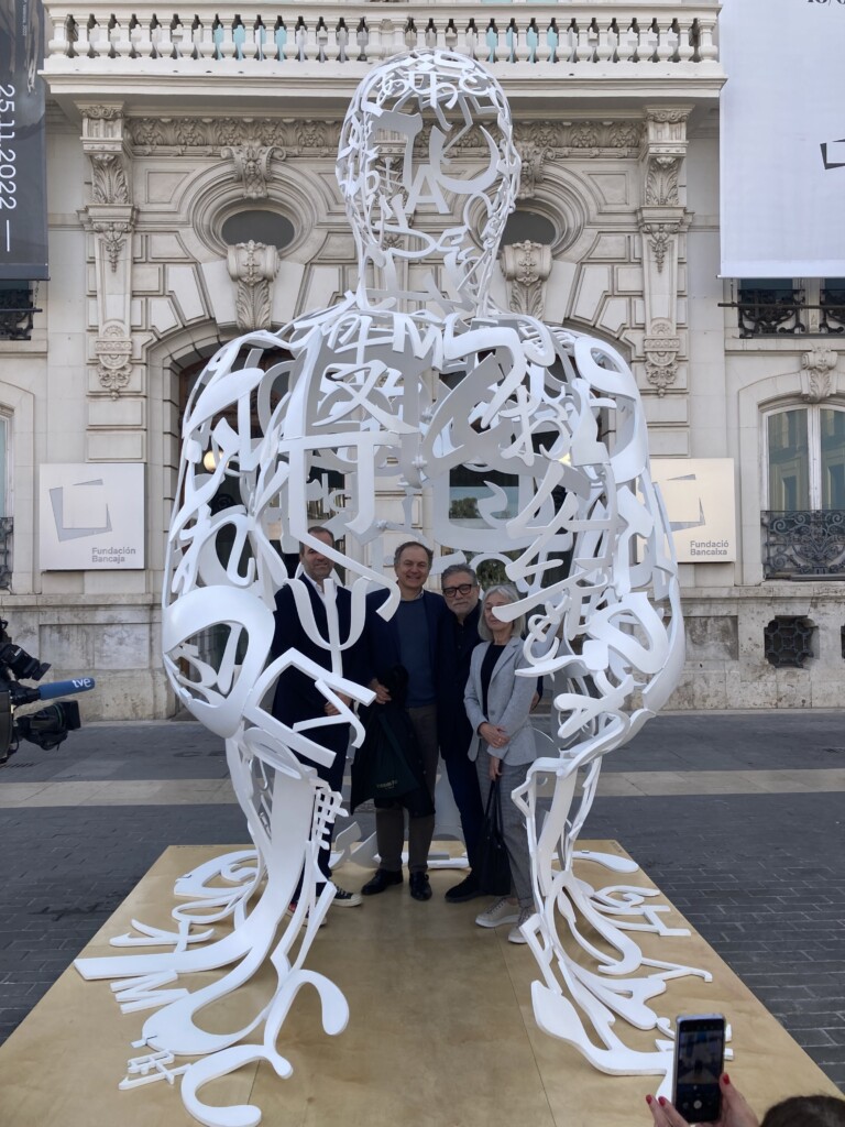 Image of three men and a woman inside a sculpture by Jaume Plensa