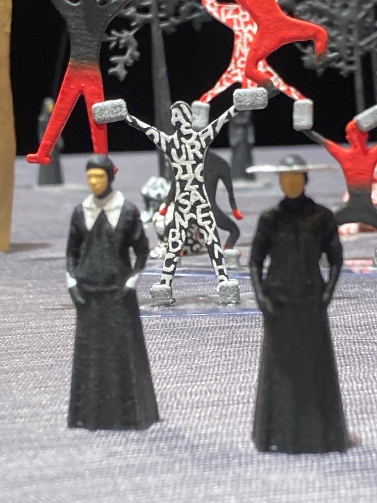 Image of white, black, red and silver colored figurines