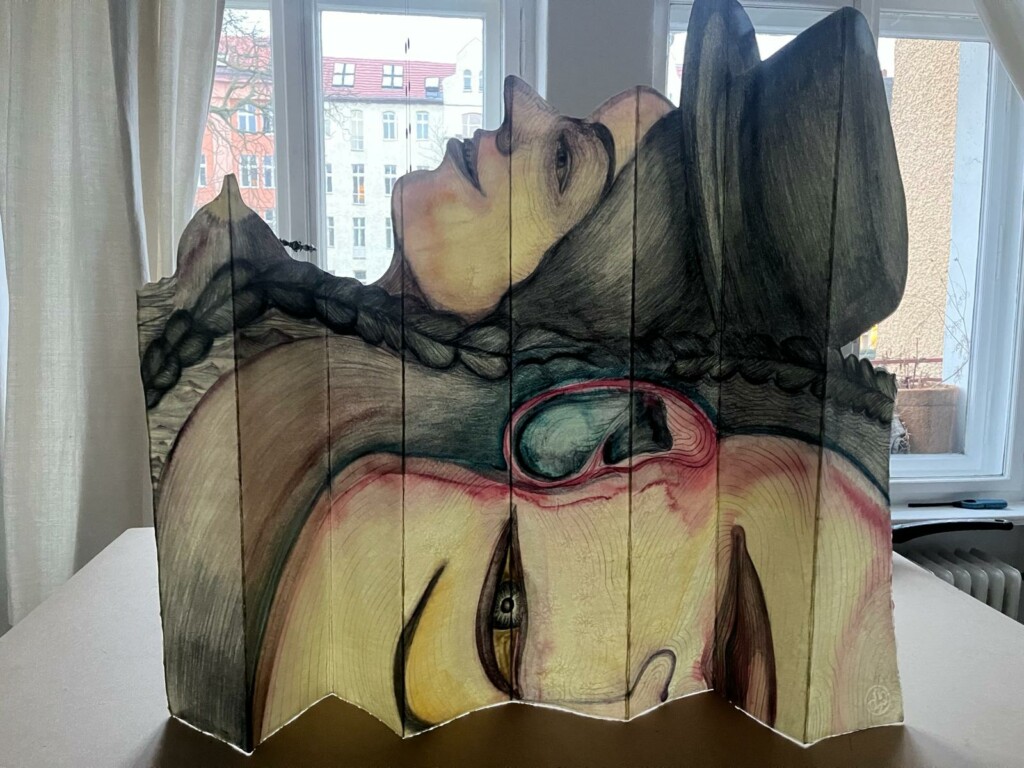 Paper art installation representing two heads, one on top of the other